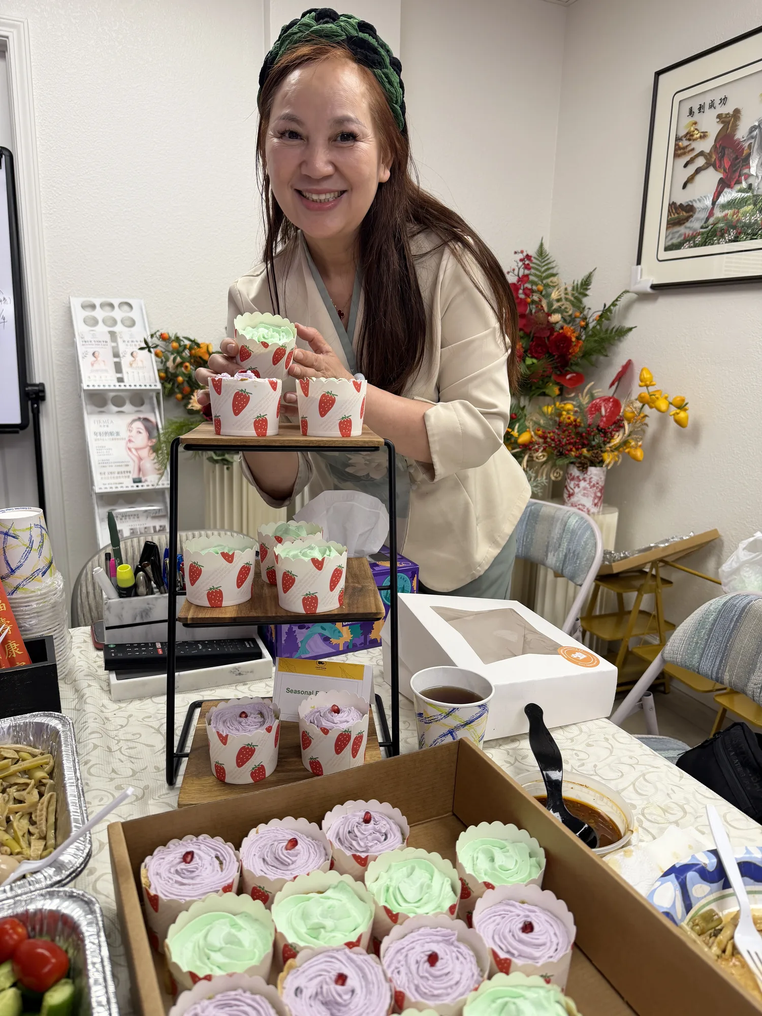 Ellaine welcoming guests with cupcakes at a Zenyra community gathering