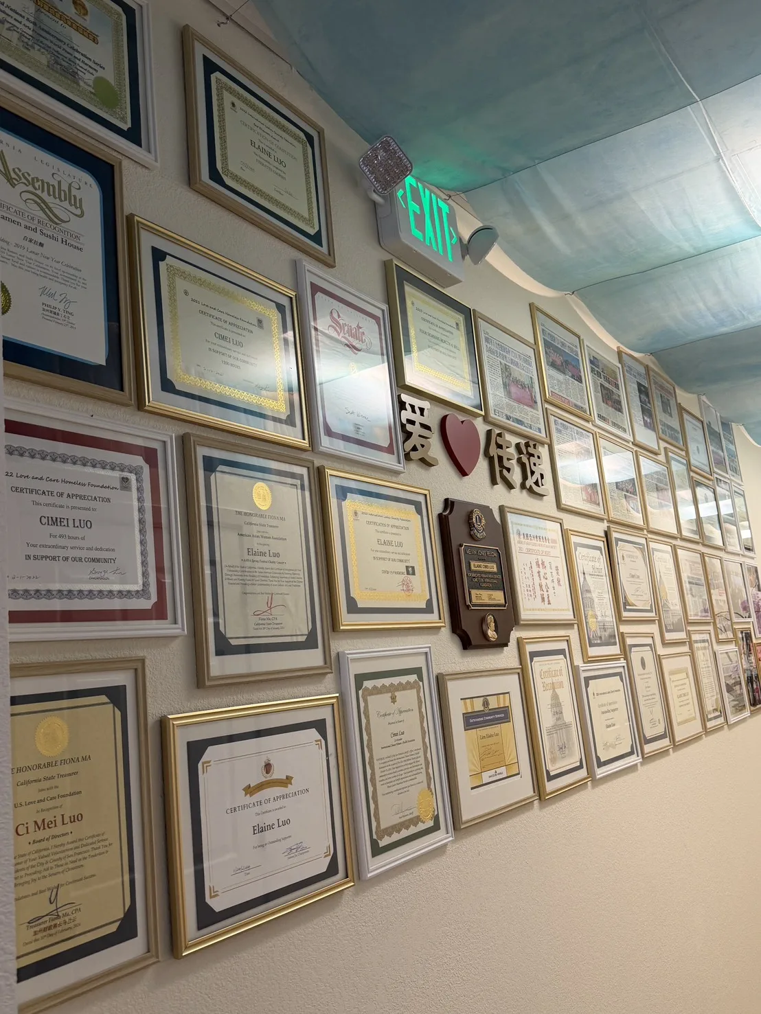 Wall filled with certificates and community recognitions