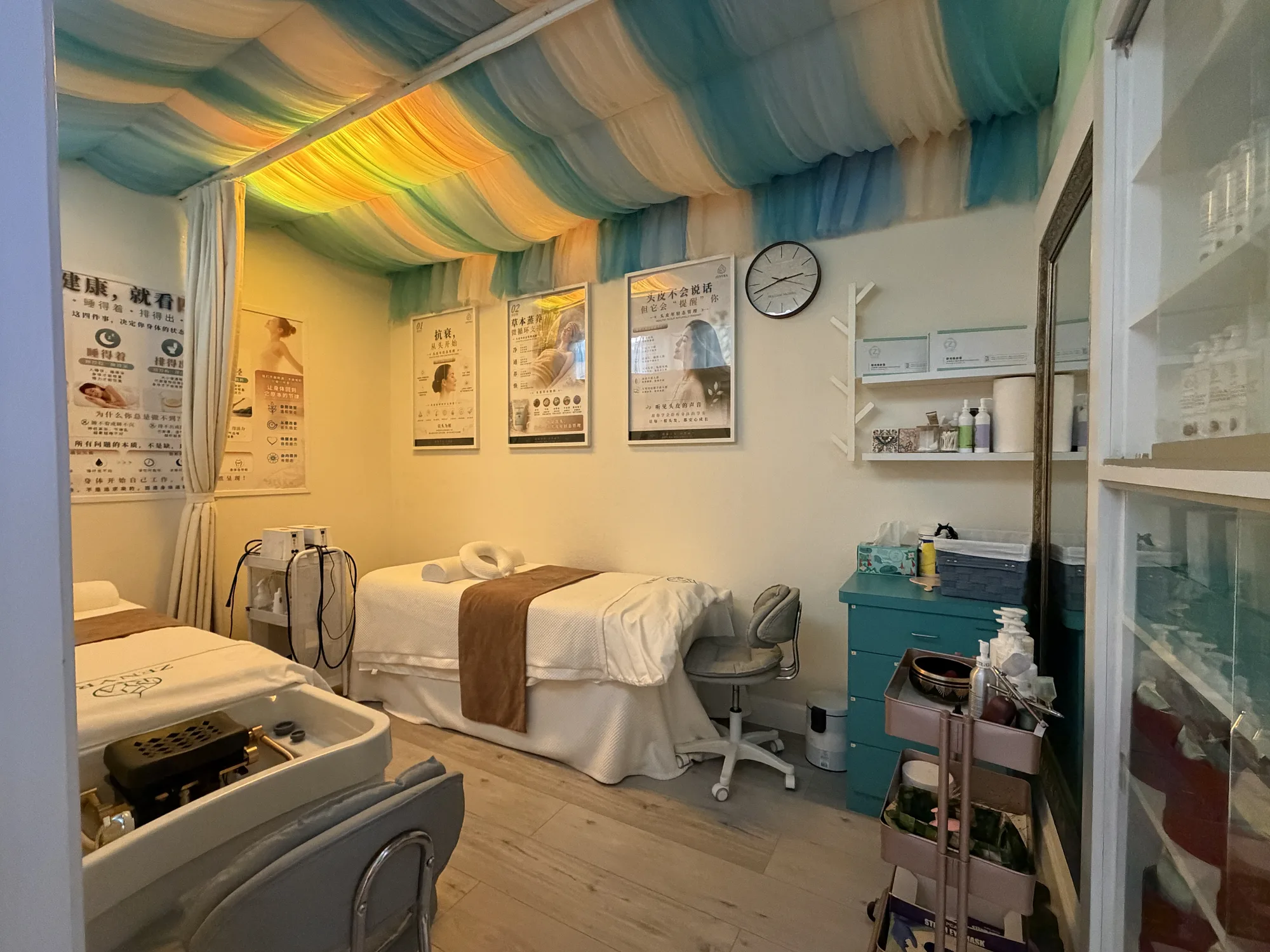 Zenyra treatment room with aqua and cream draped ceiling